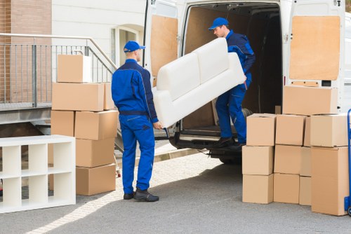 Professional Acton removals team packing and preparing household items for transport