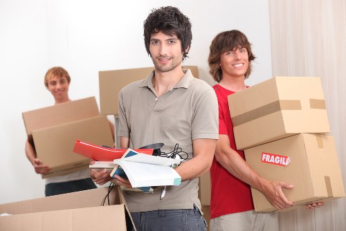 Staff using moving equipment to handle heavy furniture safely