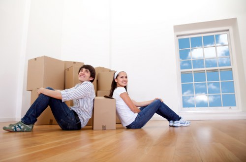 Moving team managing furniture and boxes during an Acton relocation