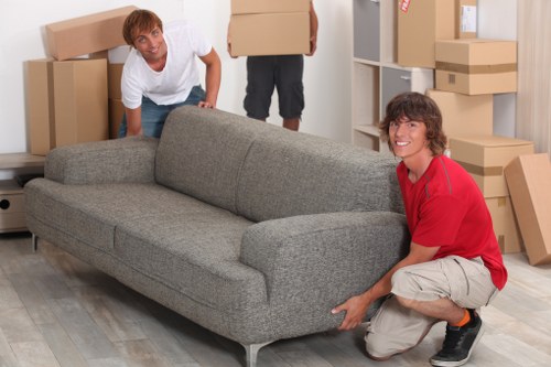 Moving boxes and household items with a van in Acton