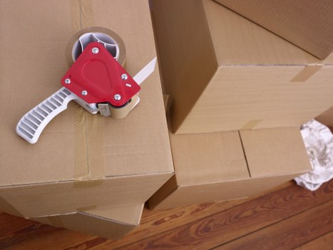Packed moving boxes and furniture ready for removals in Acton