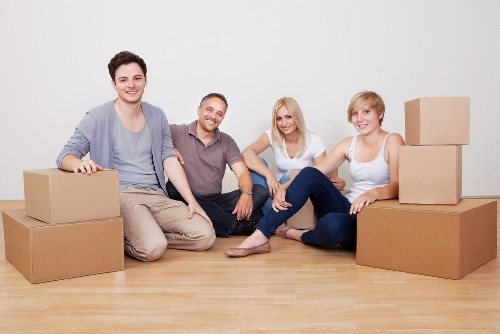 Professional movers handling household belongings in an Acton apartment move